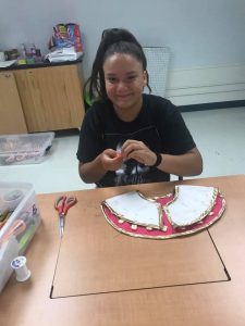 Youth making regalia for 4-H project 