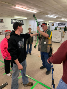 4-H shooting sports educator demonstrating proper form