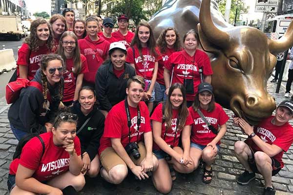 Youth in front of Wall Street bull
