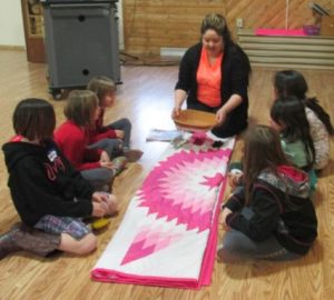 4H group in a circle learning about cultural designs.