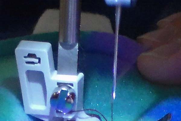 closeup of sewing machine needle