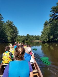 summer camp participants at upham woods on a canoe