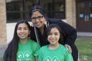 adult volunteer with two youth