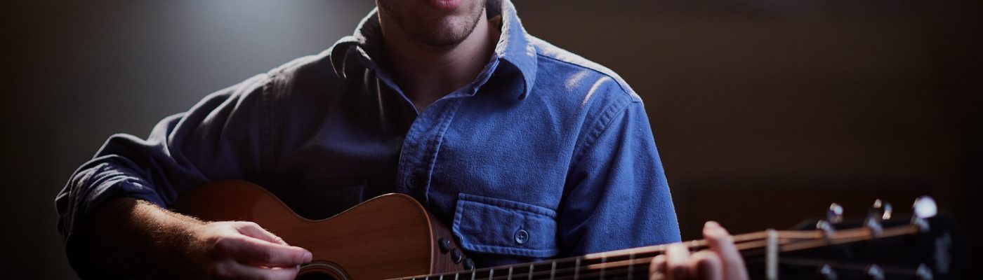 Youth playing guitar on stage