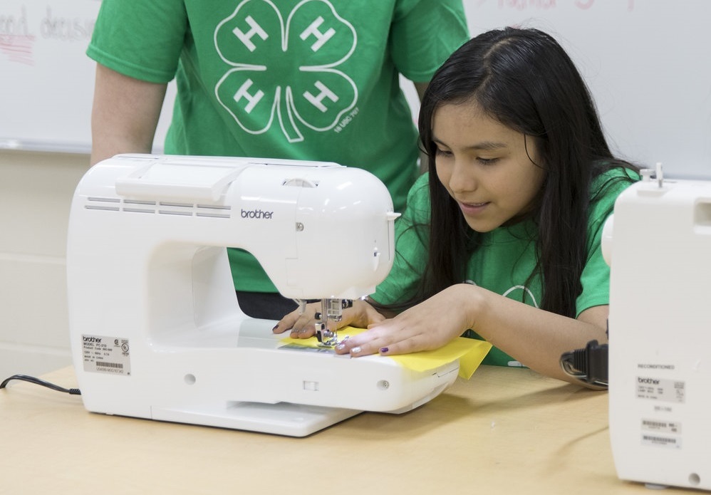 Girl using a sewing machine