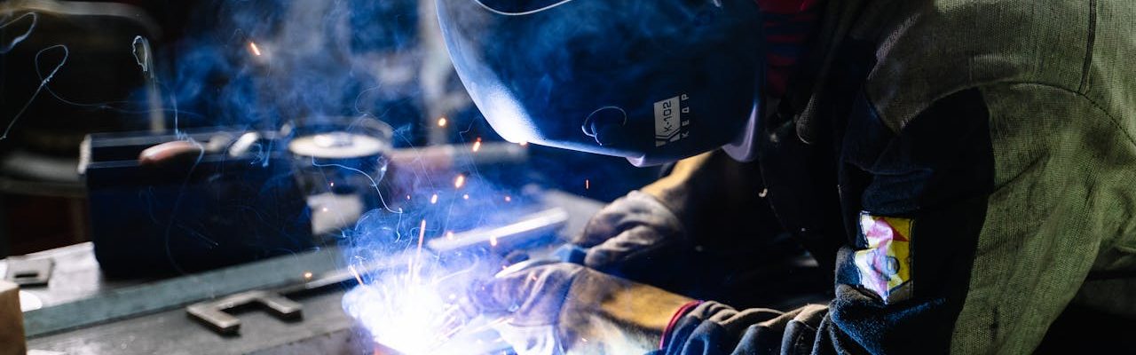 Person wearing a helmet and working on a welding project