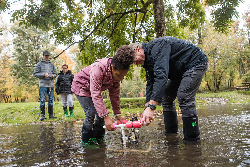 Youth and adult doing water testing activity