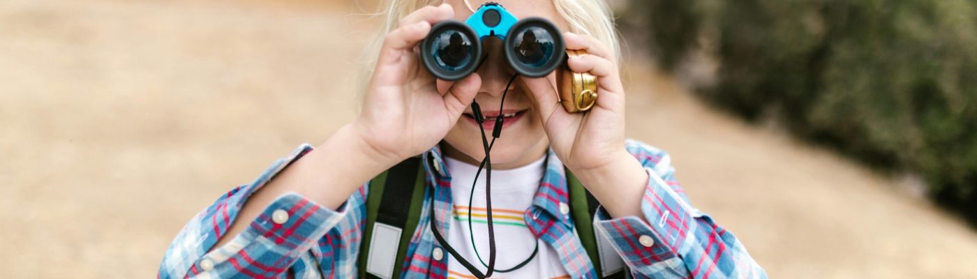 youth looking through binoculars