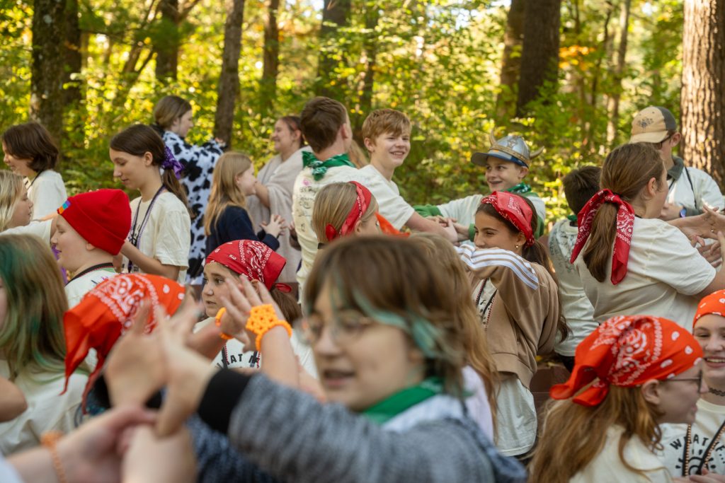 Arts Camp participants practice the official Arts Camp cheers while sporting their group's color.