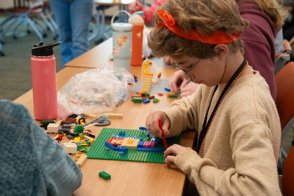Arts Camp attendee practices their creativity with Legos.